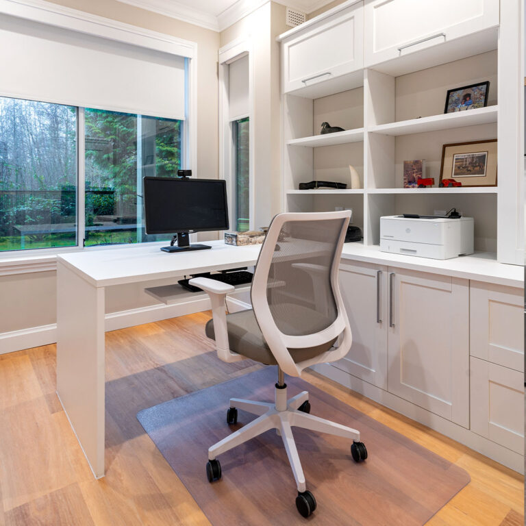 Spaces13-home-renovation-burnaby-2 Minimalistic office setup featuring a white desk, computer, and chair.