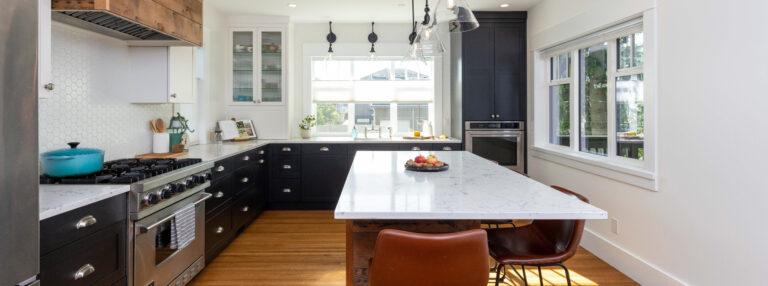 Spaces15-home-renovation-vancouver-1 A spacious kitchen with a big island and a stove. Perfect for cooking and gathering with friends and family