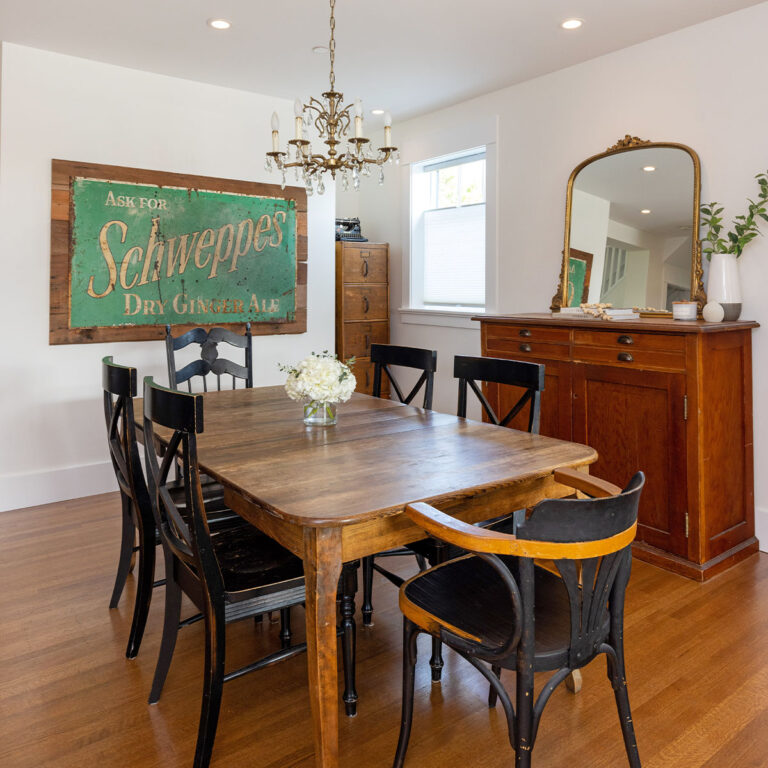 Spaces15-home-renovation-vancouver-3 Dining area featuring table, chairs, and mirror for decor.