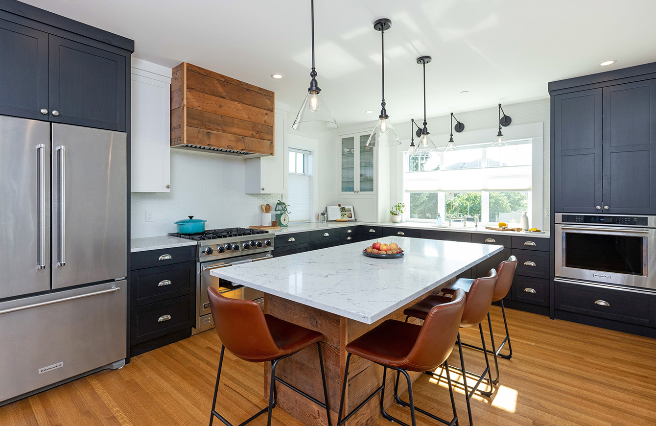 Contemporary kitchen featuring a large island and stainless steel appliances.