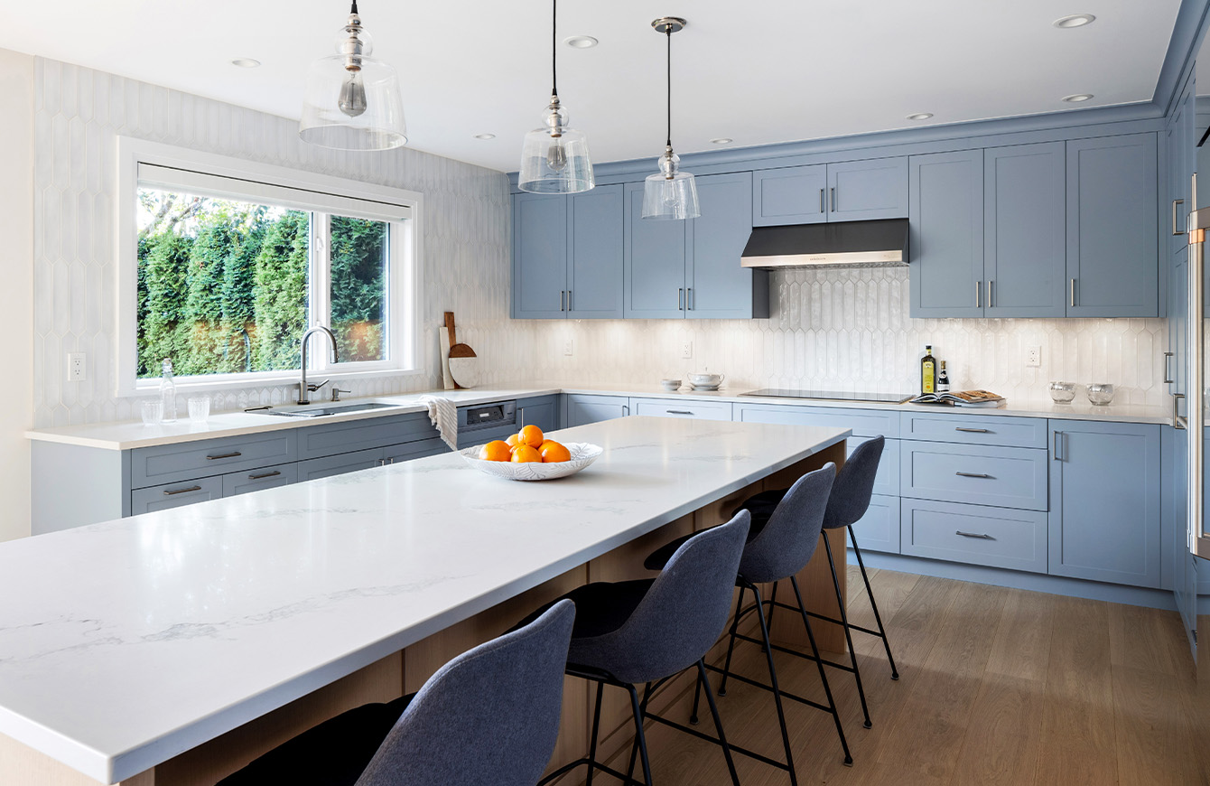 Blue cabinets and white counter in modern kitchen.