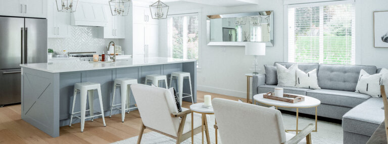 Spaces18-home-renovation-langley-1 A cozy kitchen and living room with a comfy couch and stylish bar stools. Perfect for relaxing and entertaining friends.