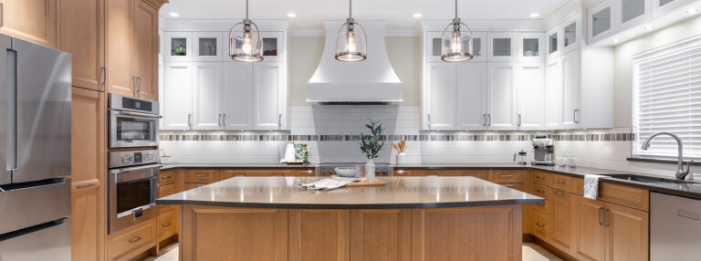 Spaces20-home-renovation-burnaby-1 Modern kitchen with center island and stainless steel appliances.