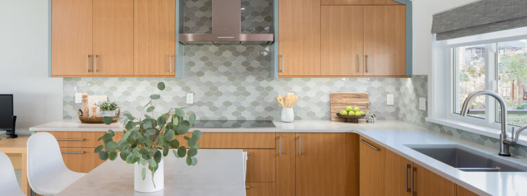 Spaces21-home-renovation-burnaby-1 Cozy kitchen featuring sink, microwave, and window.