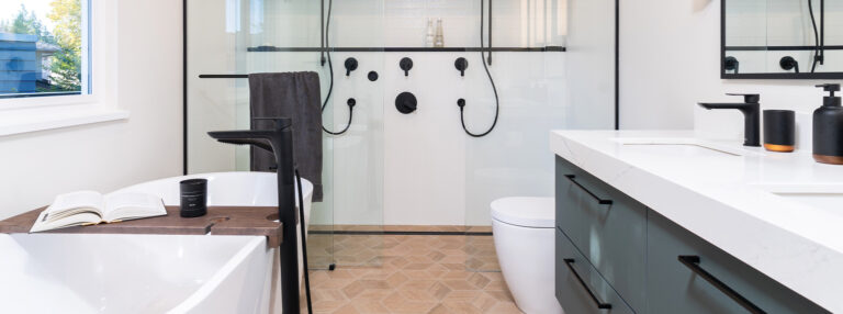 Spaces22-home-renovation-coquitlam-1 A modern bathroom with a shower, sink, and toilet.