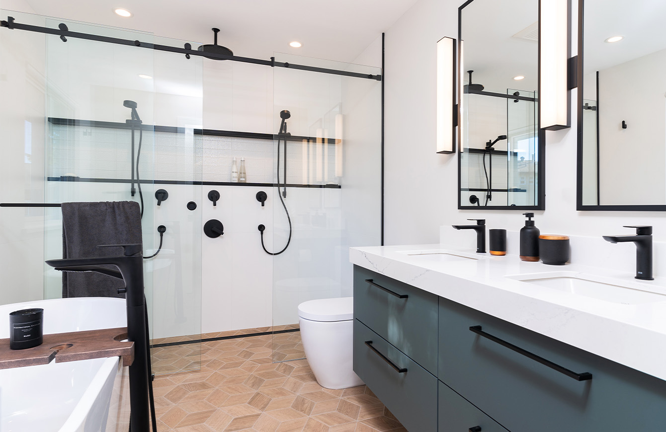 A modern bathroom with a sleek glass shower and a toilet.